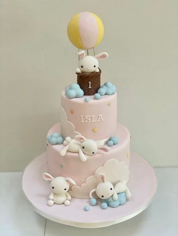 Kids birthday or babyshower cake showing a hot air balloon and lots of sugar sleeping rabbits and bunnies