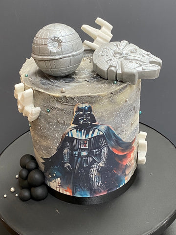 Star War themed birthday Cake wtih Darth Vadar on the front and the Death Star Space Ships