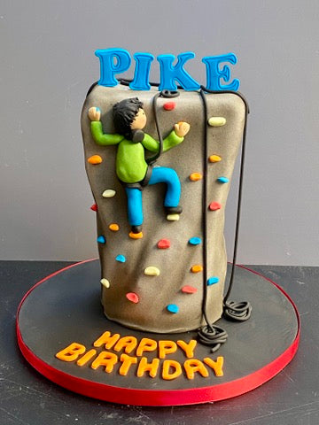 Rock Climbing themed Cake with a climber figure