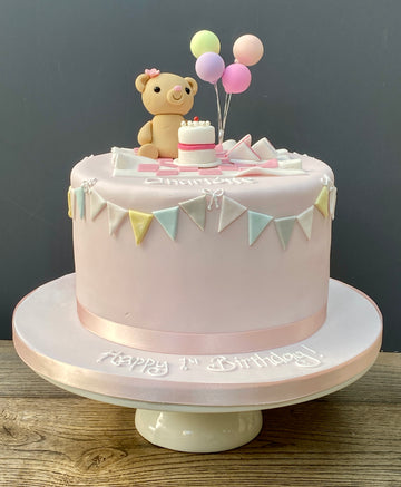 1st Birthday cake decorated with a teddy bear's picnic and balloons and bunting