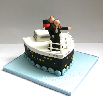 Titanic-themed cake with figures of a couple at the front replicating the scene from Titanic