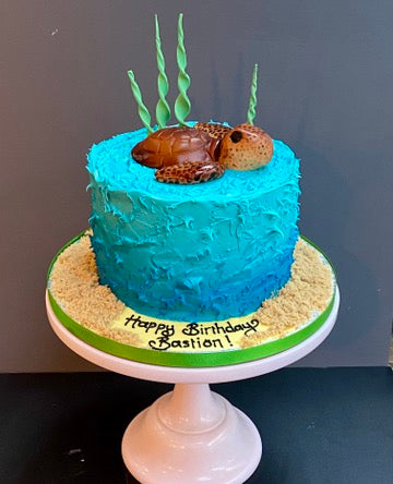 sea themed birthday cake with a turtle on top made from sugar