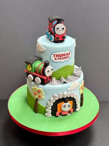 Two Tier Thomas the Tank Engine Cake with Thomas, Percy and Nia figurines on the cake