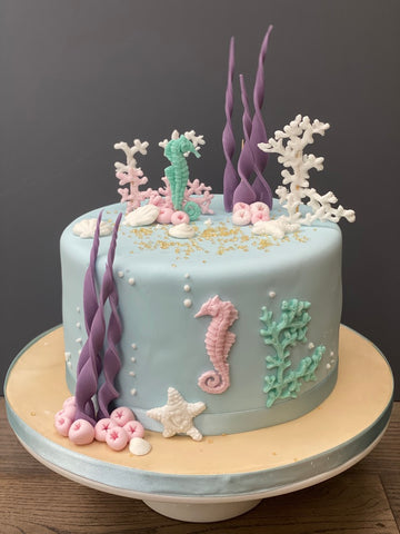 Under the sea themed cake with sea horses and seaweed