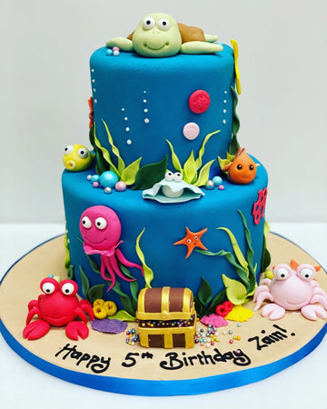 Birthday cake decorated in under the sea theme with crab, turtle, fish and octopus
