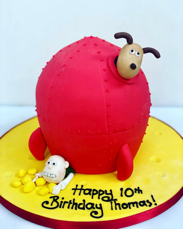 Wallace and Gromit Birthday cake carved to the shape of a space rocket