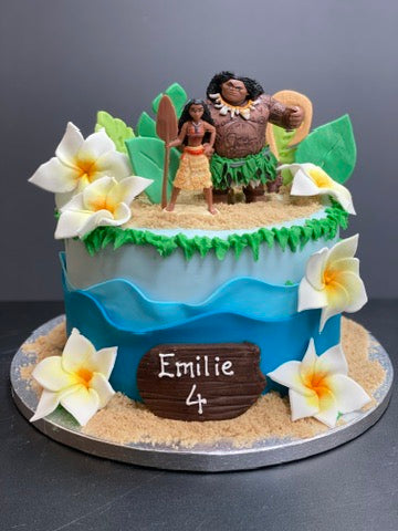Birthday cake decorated with waves and tropical flowers