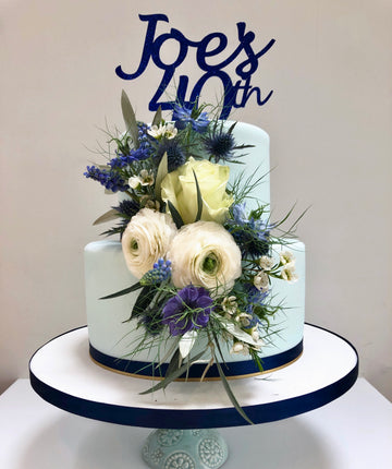 2 Tier Blue Birthday Cake With Blue and White Flowers