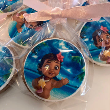 Cookies with Moana design in clear packaging on a white surface