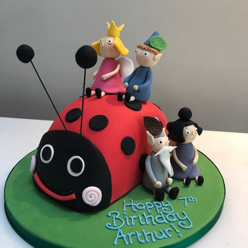 cake shaped like gaston from ben and holly and the characters all made from sugar decorate this birthday cake