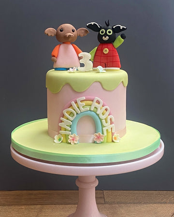 Bing birthday cake with Bing and his friend on a pretty cake with a rainbow