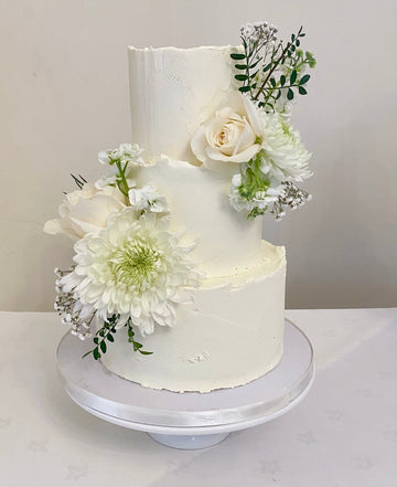 Buttercream Rustic Wedding Cake with fresh flowers delivered in london