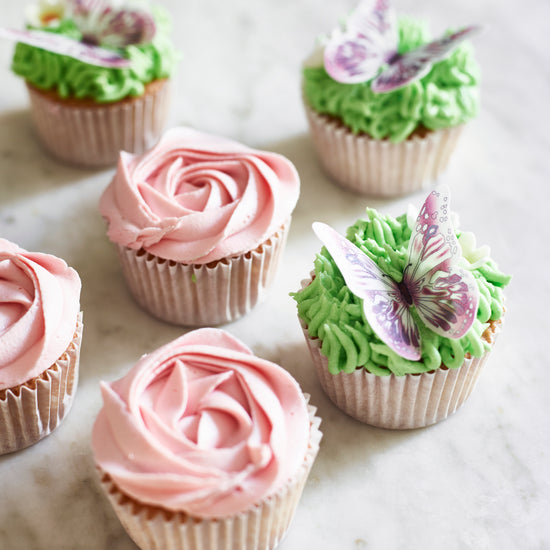 cupcakes decorated with a rose and butterflies 