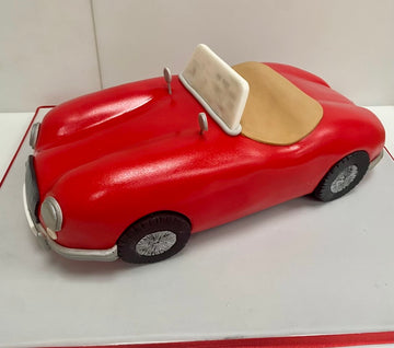 Cake carved to the shape of a convertible MG