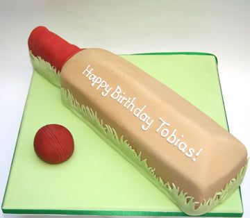 Cake shaped like a cricket bat and a cricket ball