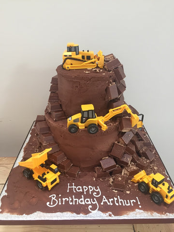 Diggers and construction diggers on a cake