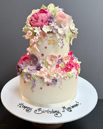 Extravagant Sugar Flower Pink and Purple Birthday Cake with lots of sugar flowers tumbling all over the cake