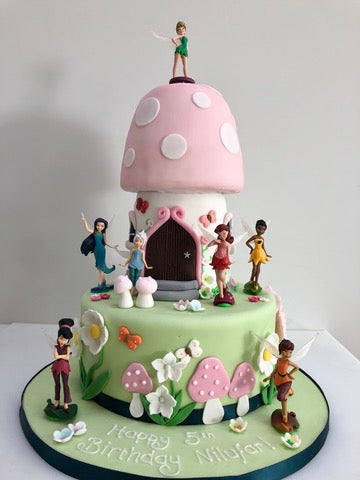 Birthday cake carved to the shape of a toadstool fairy home