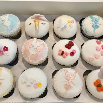 Cupcakes decorated with fairies and butterflies, hearts and blossoms
