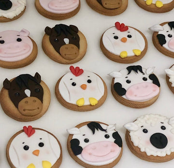 Cookies decorated with farmyard animal faces