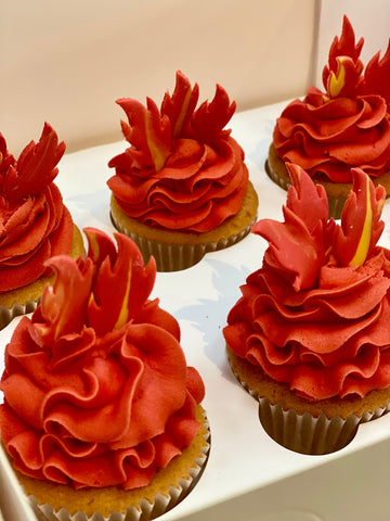 Cupcakes decorated with red icing to look like fire and flames