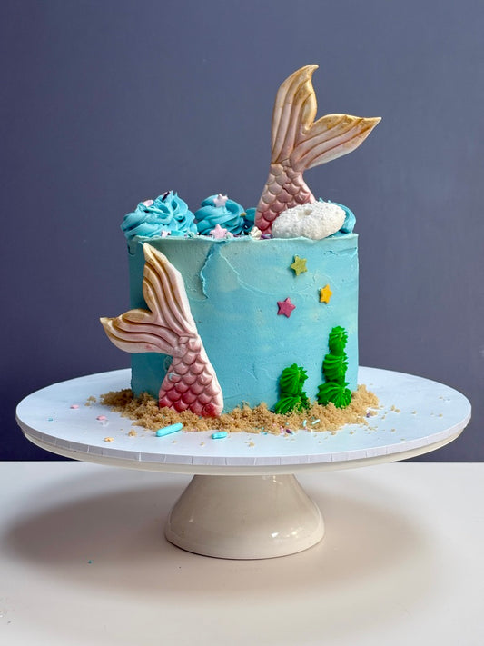 Mermaid-themed Buttercream birthday cake with mermaid tails and ocean decorations ready to order in london