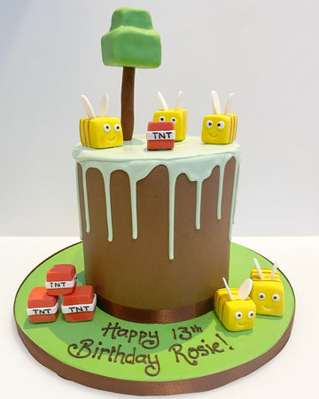 Minecraft Bee Drip Birthday Cake delivered in london with minecaft bees on top and blocks of tnt and a minecraft tree all made from sugar
