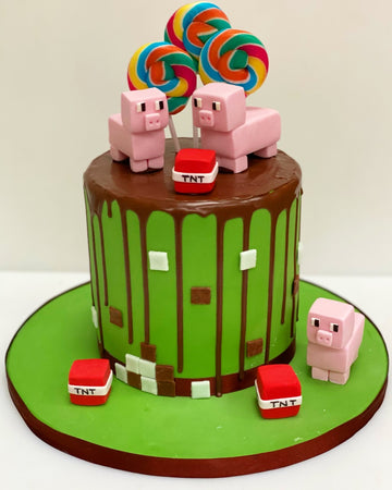Minecraft Drip Cake with Minecraft Pigs and TNT blocks made from sugar, swirly candy lollies on top delivered London