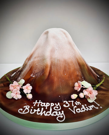 Cake carved to the shape of mount fuji with cherry blossom around it
