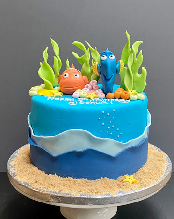 sea themed birthday cake with Nemo and Doreen on top