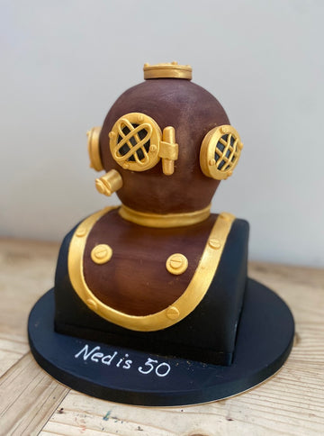 Diver's helmet cake with gold detailing 
Cake Carved to look like an old fashioned antique diver's helmet