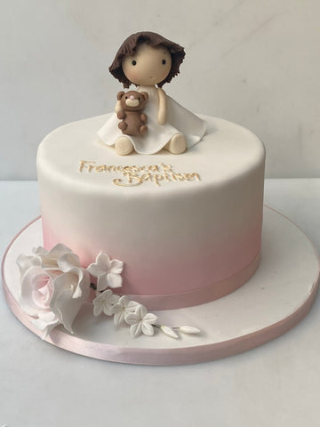 Ombre christening cake decorated with a little girl and sugar flowers