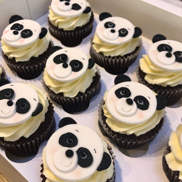 Cupcakes decorated with hand made panda face toppers