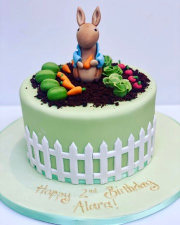 Birthday Cake decorate with peter rabbit in his garden