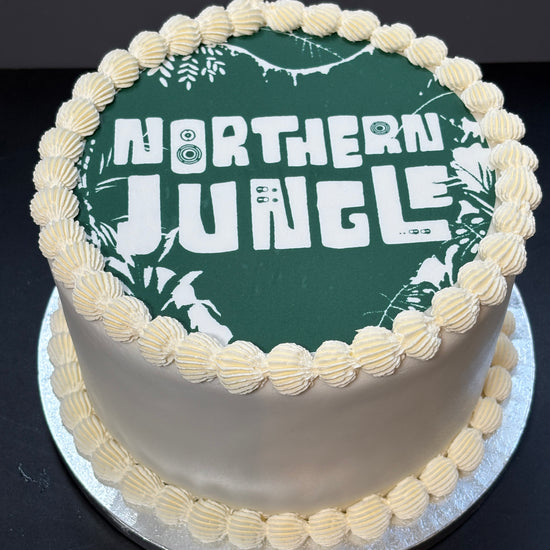 Cake with an edible printed image on top, finished with lambeth piping