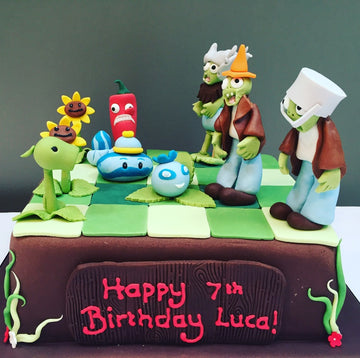 Plants vs Zombies Cake delivered in london with the various plants and zombies made from icing on top
