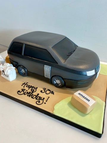 Cake carved to look like a range rover with packages next to it