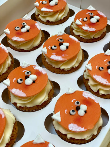 Cupcakes decorated with red fox panda faces