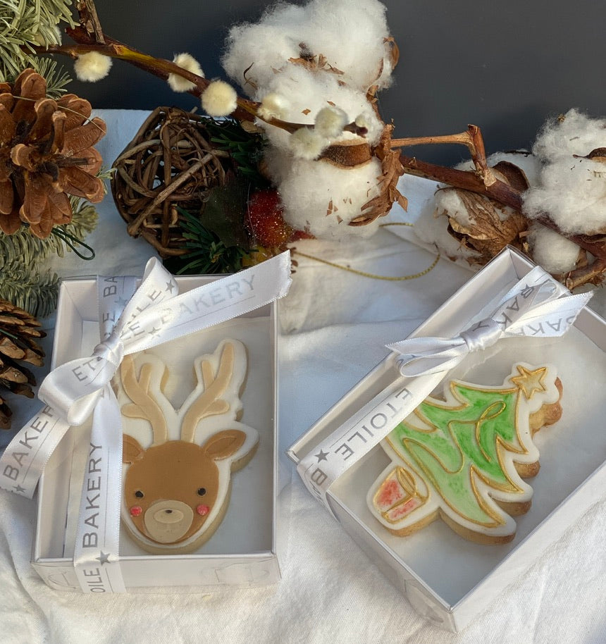 Box of beautiful sugar cookies with a reindeer on one beautifully packaged and ready to send across the uk
