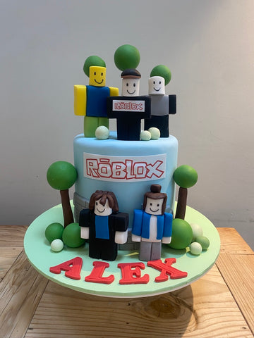 Roblox themed birthday cake with sugar figurines
