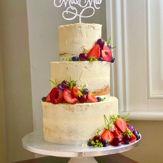 Semi naked wedding cake with fruit delivered in london