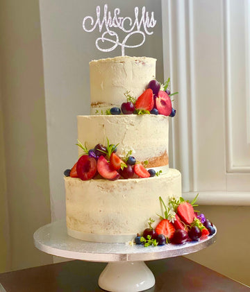 Semi naked wedding cake with fruit delivered in london