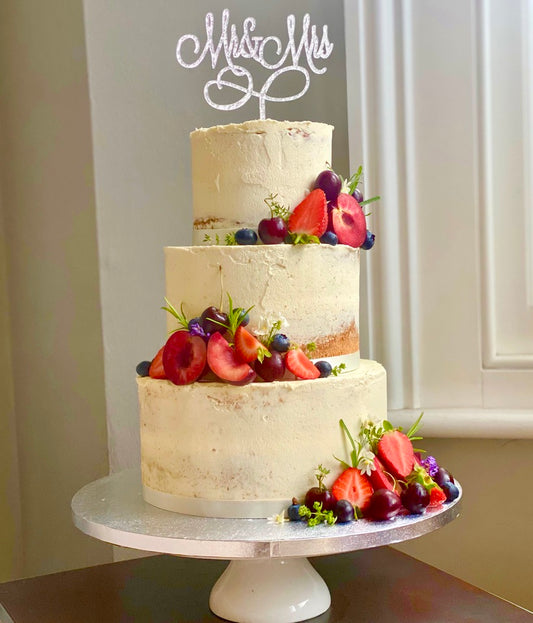 Semi naked wedding cake with fruit delivered in london