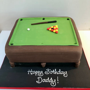 Pool table cake with billiard balls and a cue, 