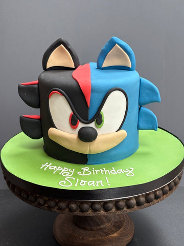Sonic the Hedgehog Birthday Cake with half the cake the blue sonic and half the black and red sonic
