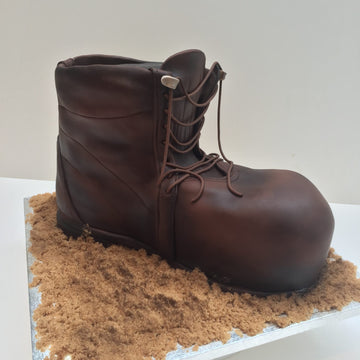 Cake shaped and decorated to look like a walking boot