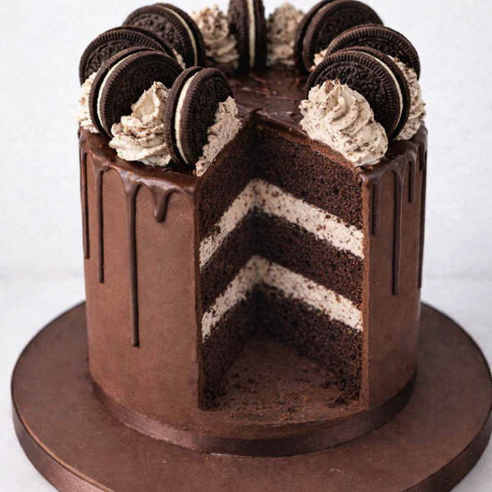 oreo chocolate drip cake showing a slice taken out of the cake delivered in london