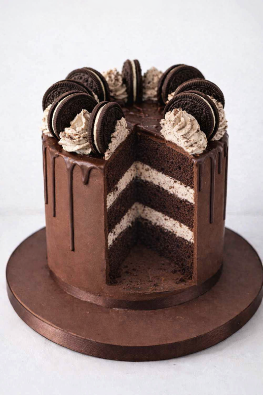 oreo chocolate drip cake showing a slice taken out of the cake delivered in london