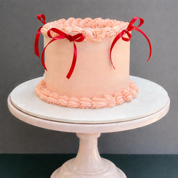 pink valantine cake with red ribbons and piping for delivery in london